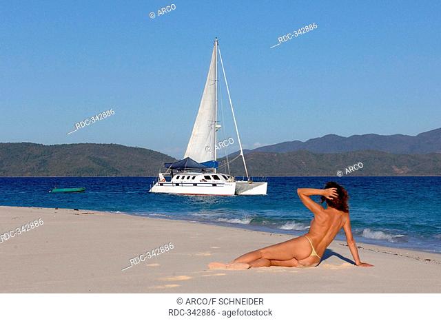 Woman at beach and catamaran, southsea / yacht