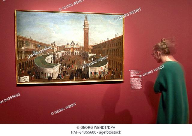 An employee of the gallery looking at the oil paintings 'Die neue Messe auf dem Markusplatz waehrend der Festa della Sensa'