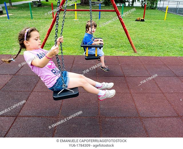 Children go on swing at the playground