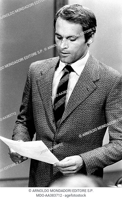 Terence Hill in The true and the false. Italian actor Terence Hill (Mario Girotti) reading a paper in the film The true and the false. Rome, 1972