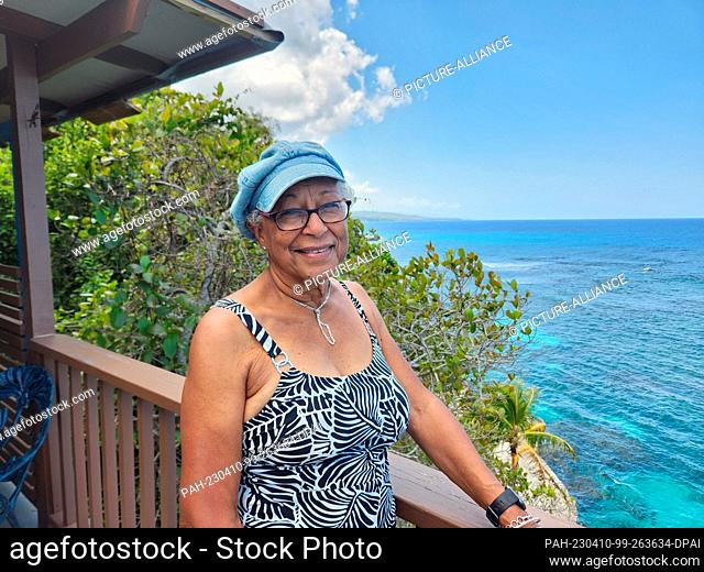 PRODUCTION - 01 April 2023, Jamaica, Oracabessa: 81-year-old Penny Dyer stands on her balcony on a neighboring property at the Goldeneye resort in the northern...