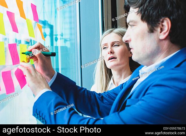 Group of business people brainstorming ideas. Entrepreneurs having a standing meeting discussing ideas strategy planning problem solution concept