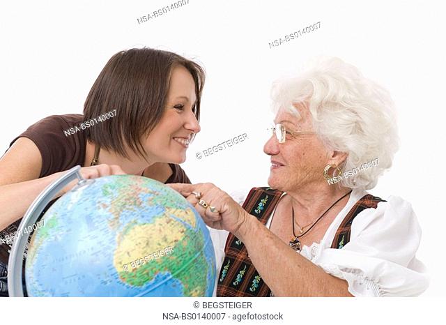 young woman and older person with globe