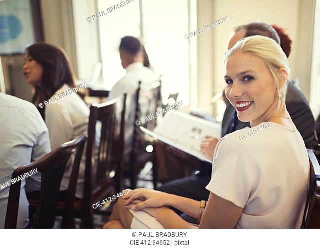 Portrait confident businesswoman in business conference audience