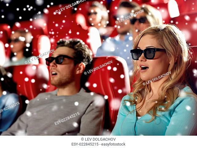 cinema, technology, entertainment and people concept - young woman in 3d glasses watching horror or thriller movie with friends in theater with snowflakes