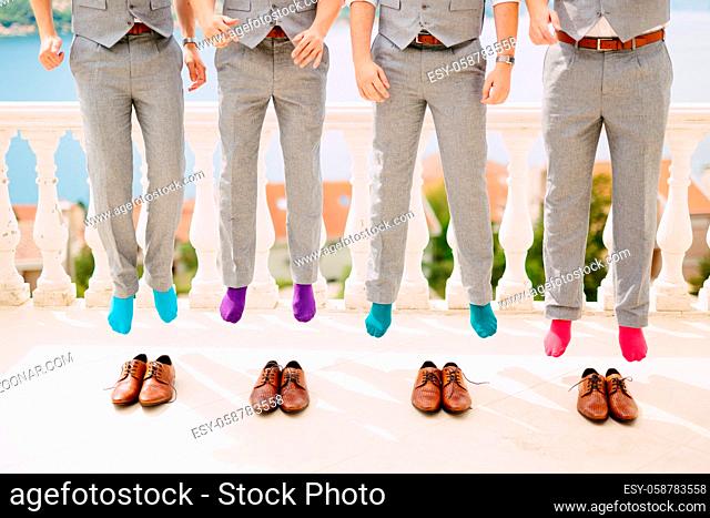 Men in colorful socks. Funny wedding photos. Wedding in Montenegro