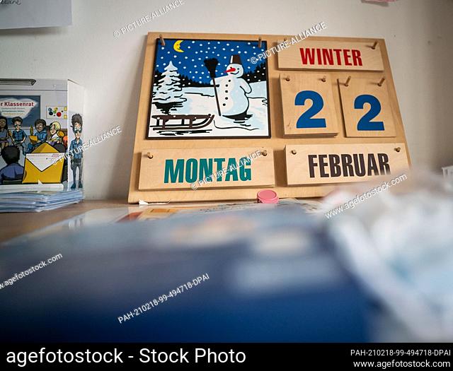 18 February 2021, Hessen, Frankfurt/Main: The date ""Monday, February 22"" is set on a wooden calendar in a classroom at the Valentin Senger School in the...
