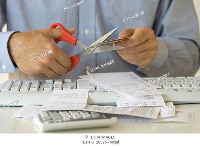 Man cutting up credit card