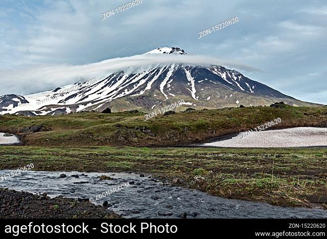 Kamchatka Peninsula beautiful mountain landscape on cloudy day: view of Oval Zimina Volcano and mountain river. Eurasia, Russian Far East, Kamchatka Region