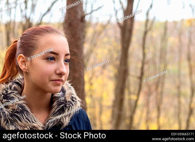 Cute beautiful pretty redhead female teenager in autumn forest. Close up charming portrait, shallow depth of field, toned