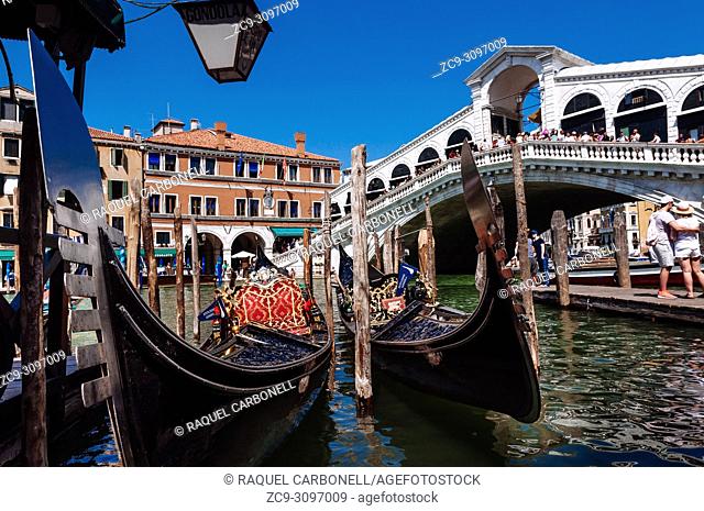 Gondolas moored on the Grand Canal next to Rialto Bridge, Venice, Veneto, Italy