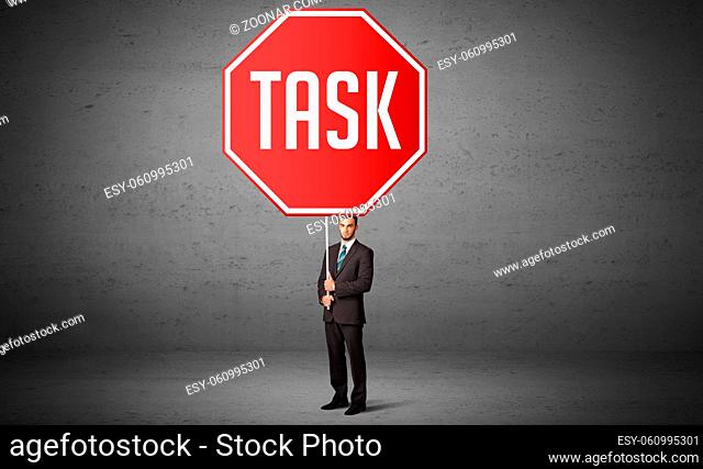 Young business person holding road sign with TASK inscription, new rules concept