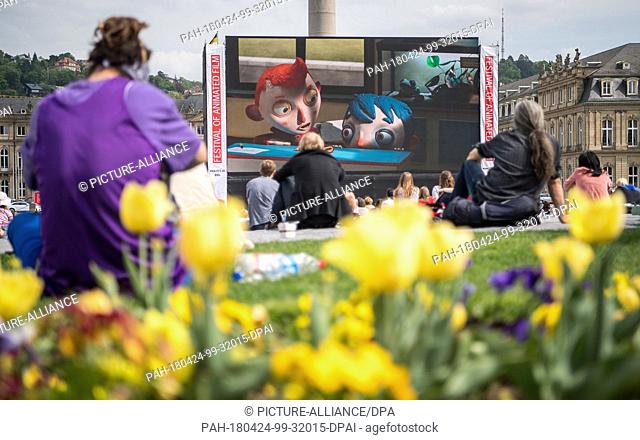 dpatop - 24 April 2018, Germany, Stuttgart: Visitors watching ""My Life as a Courgette, "" the first film running on the open-air stage of the International...