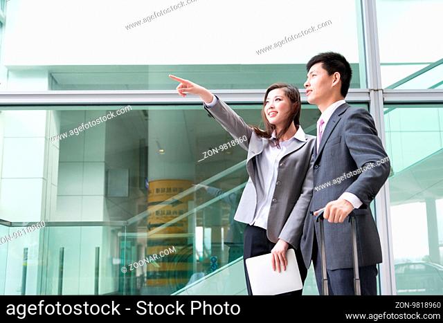 asian beautiful girl and businessman with tablet in modern hall