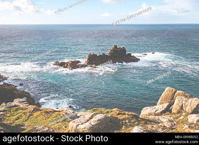 Waves and spray on the rock, on the coast at Lands End, Penzance, Cornwall, England, UK