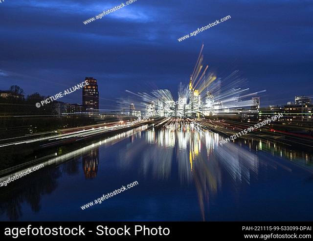 15 November 2022, Hessen, Frankfurt/Main: The bank skyline of Frankfurt shines in the last light of the day (shot with zoom effect)