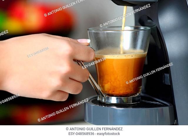 Close up of a woman hand using a coffee maker