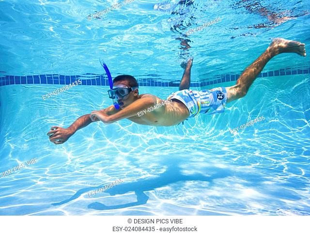 Young Man Swimming in Pool Underwater
