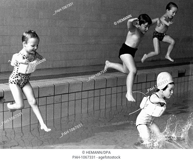 Disabled children, some wearing flotation devices - some don't, jump courageously into the water in a photograph taken in May 1968