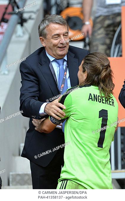 Nadine Angerer of Germany shakes hands with the president of the German Football Association (DFB) after winning the UEFA Women's EURO 2013 final soccer match...