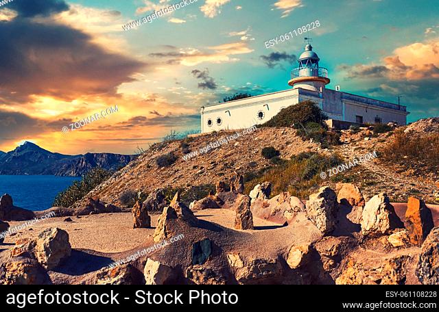 Lighthouse El Hoyo in Portman village view during picturesque bright sunset cloudy sky background, Europe, Cartagena. Spain