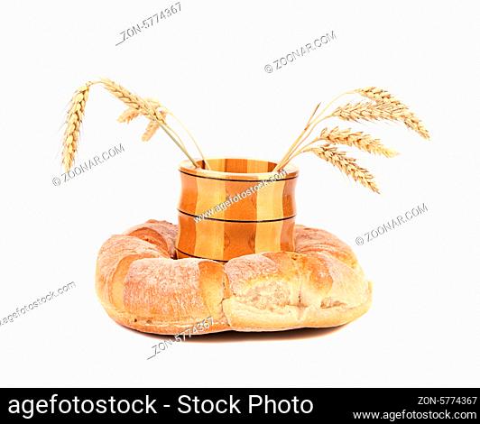 Wooden jar with ears into kalatch. Isolated on a white background