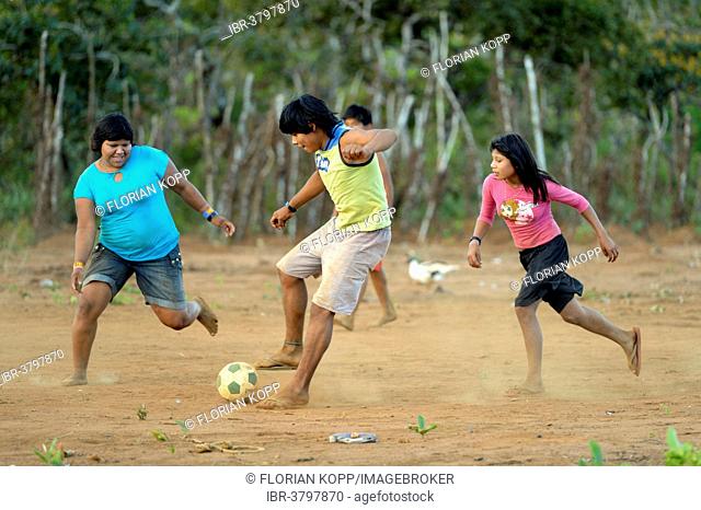 Youngers of the indigenous Xavante people playing football, village of Tres Rios near Sangradouro, Primavera do Leste, Mato Grosso, Brazil