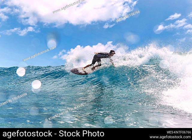 Man surfing in sea on sunny day