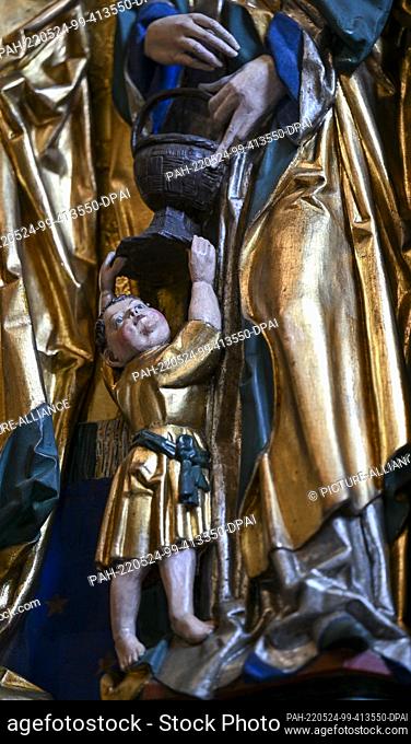 24 May 2022, Saxony-Anhalt, Köthen: The scene of a boy with a basket on the robe of St. Dorothea is depicted on the feast day side of the late Gothic high altar...