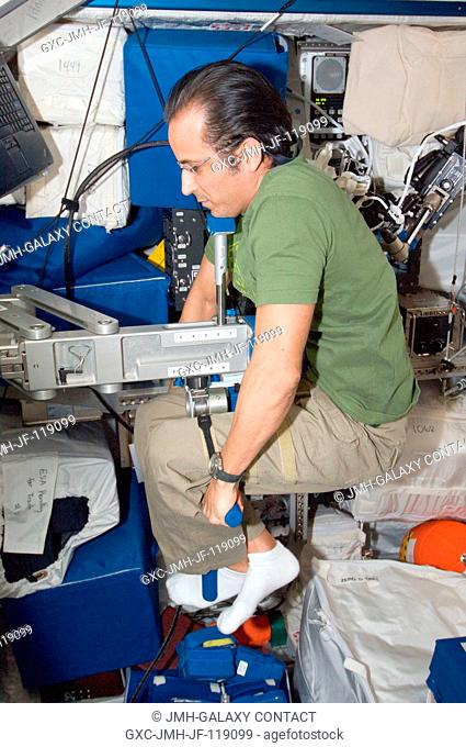 NASA astronaut Joe Acaba, Expedition 32 flight engineer, uses the Space Linear Acceleration Mass Measurement Device (SLAMMD) in the Columbus laboratory of the...