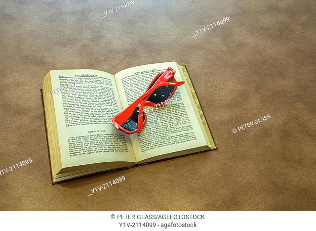 Sunglasses on an opened book