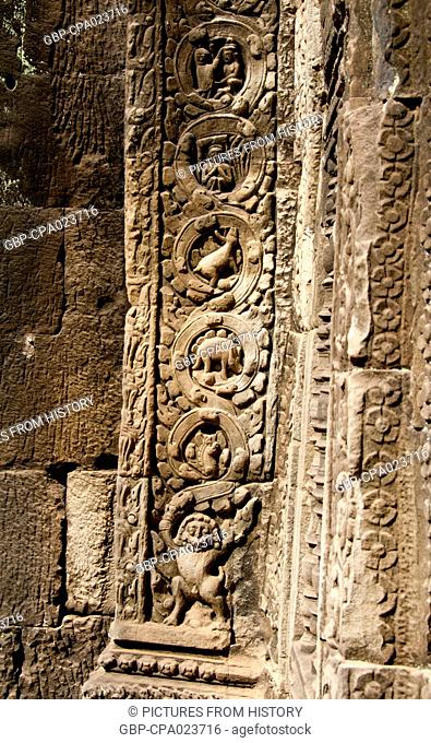 Cambodia: One of Angkor's mysteries, a dinosaur roundel (4th down, looking like a stegosaurus) on a pillar in Ta Prohm, Angkor