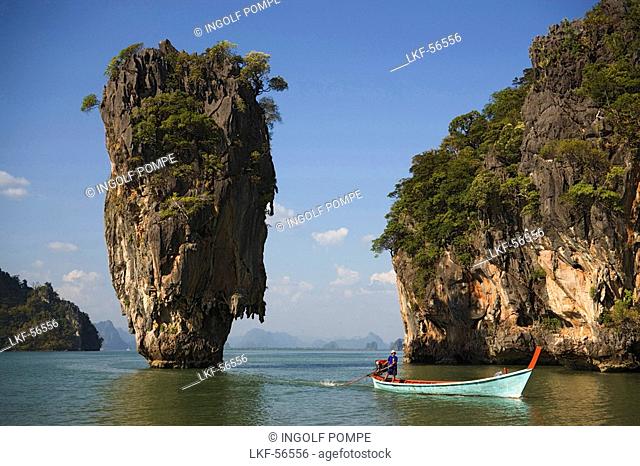 View to Koh Tapu, so-called James Bond Island, The Man with the Golden Gun, people in a longtail boat in foreground, Ko Khao Phing Kan, Phang-Nga Bay