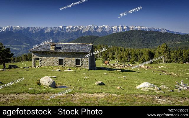 Pradell refuge in spring. In the background, the Serra del Cadí mountain range (Cerdanya, Catalonia, Spain, Pyrenees)