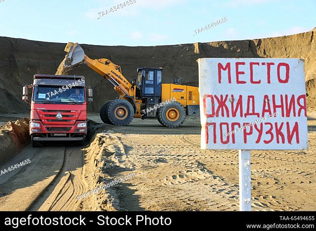 RUSSIA, DONETSK PEOPLE'S REPUBLIC - DECEMBER 5, 2023: A dump truck and a wheel loader in Telmanovsky granite quarry run by the Nedra state corporation