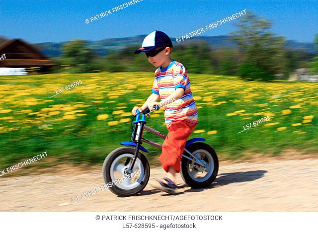 boy riding bicycle / Like a  Bike, in spring, Gossau ZH, Zuerich, Switzerland