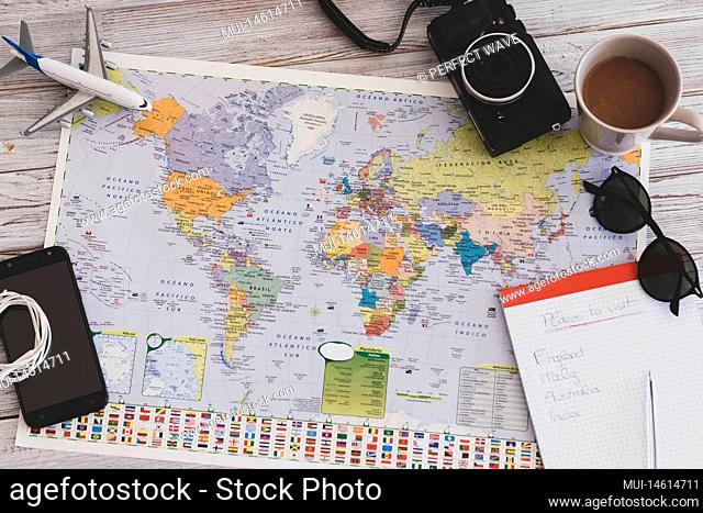 close up and portrait of above and top view of a white wooden table with map and things about vacations and travelling - holiday and journey away lifestyle and...