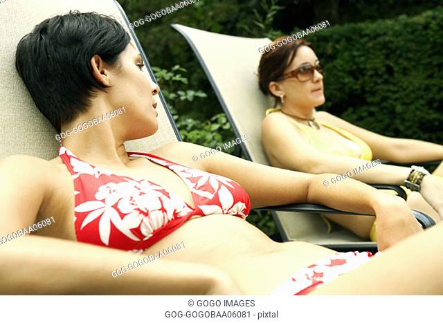Young women relaxing in lawn chairs