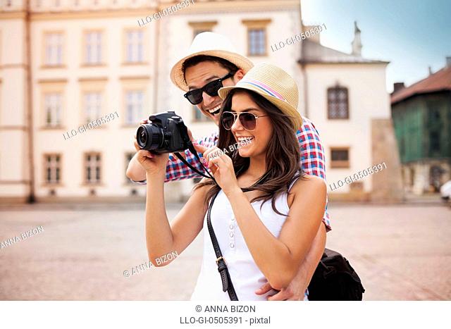 Cute couple looking on their photos on camera, Debica, Poland