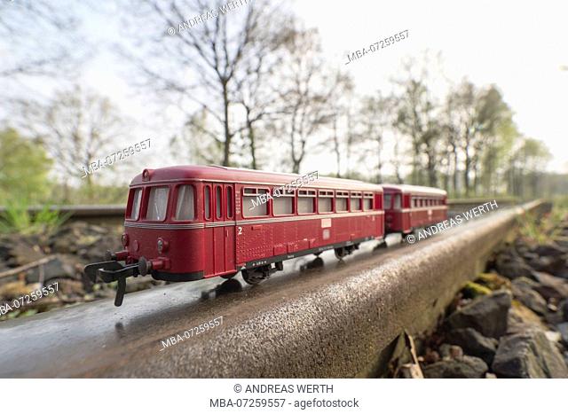 Red train model, bus-style train, on real rails, original train served as local public transport, Celle, Germany