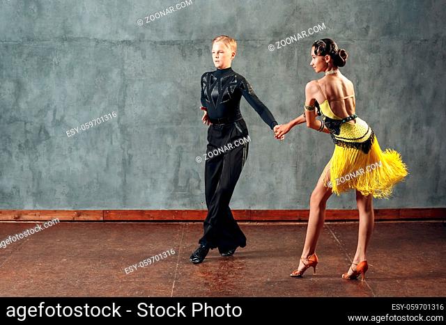 Young couple dancers dancing ballroom dance cha cha cha
