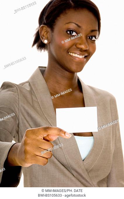 a young black woman holds up a business card