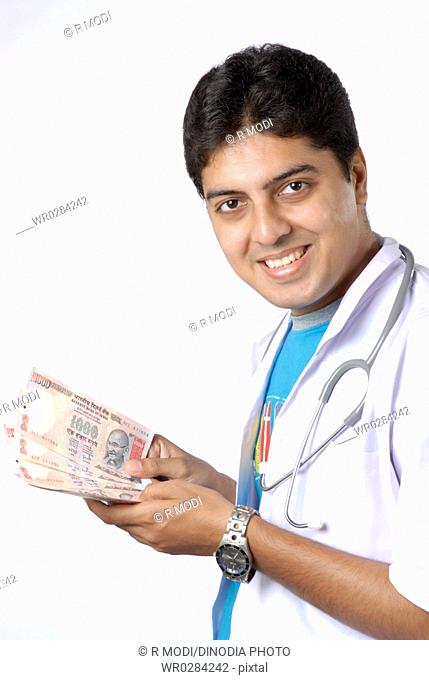 South Asian Indian doctor with stethoscope around neck earn lot of money MR628