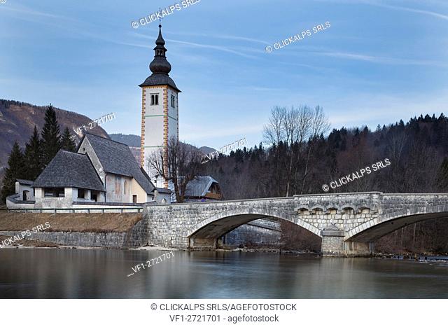 Europe, Slovenia, Upper Carniola. Church of Sv. John the Baptist and the stone bridge by the Bohinj lake