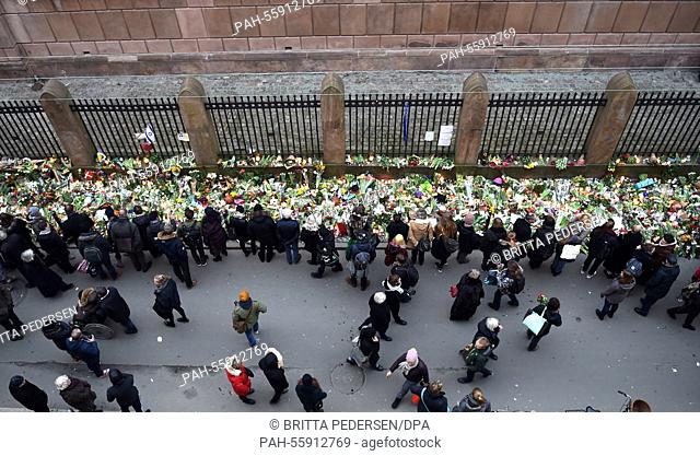 People lay down flowers at a synagogue in Copenhagen, Denmark, 16 February 2015. Danish police said that a man they shot dead in Copenhagen on Sunday 15th is...
