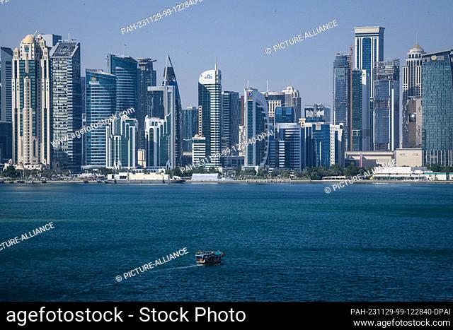 29 November 2023, Qatar, Doha: A boat passes in front of the skyline of Doha (Qatar). The metropolis on the Persian Gulf has been growing steadily for decades