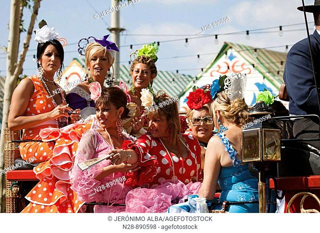 Women taking a ride on a coach in the Seville Spring Fair, Seville, Andalusia, Spain