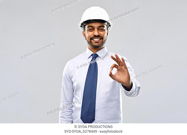 architect or businessman in helmet showing ok