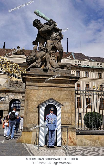 guard under one of the statues, depicting Giants fighting, at the entrance of Castle of Prague, Czech Republic, Europe