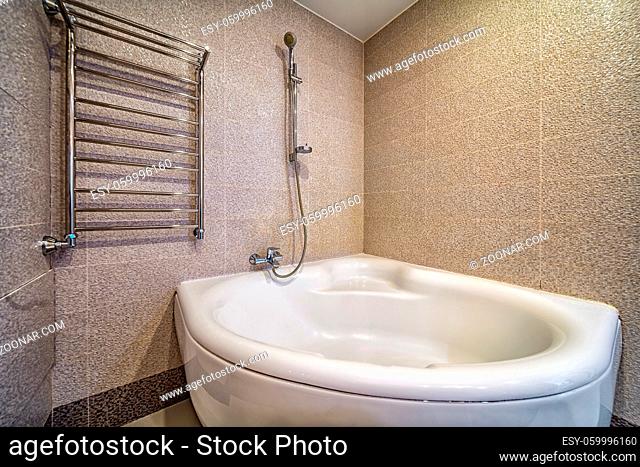 Spacious newempty jacuzzi bath tube in bathroom interior with modern tile